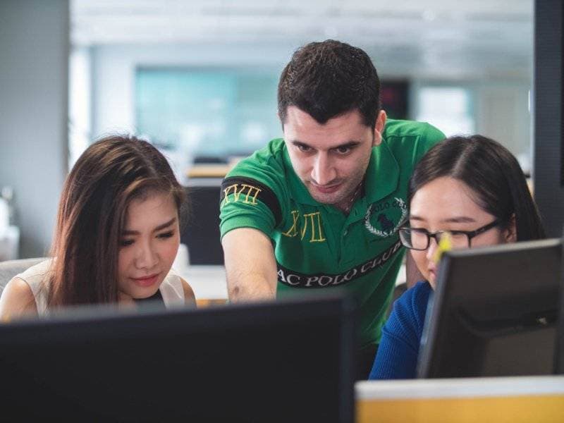 College Students Looking a Laptop