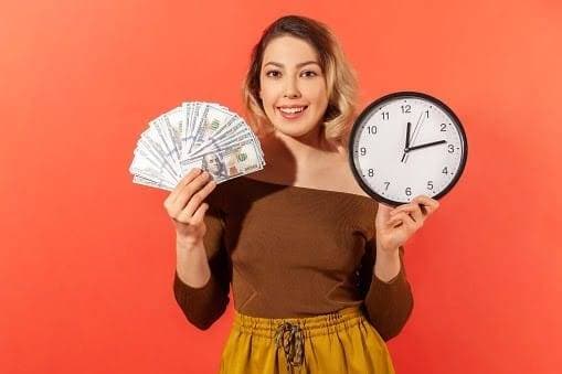 Woman Holding Dollar Bills and a Clock