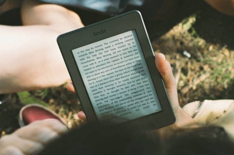 A reader reading an ebook on Kindle