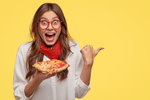 Woman happy with slice of pizza