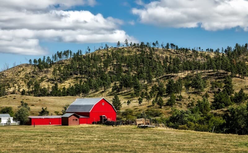 Red Wooden Shed on Farm Land for storage