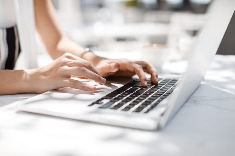 Woman focused on her laptop, engaged in online work