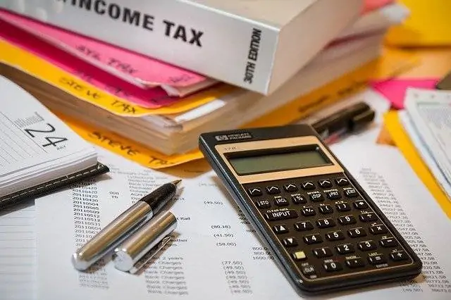 Tax Book, Pen, and a Calculator