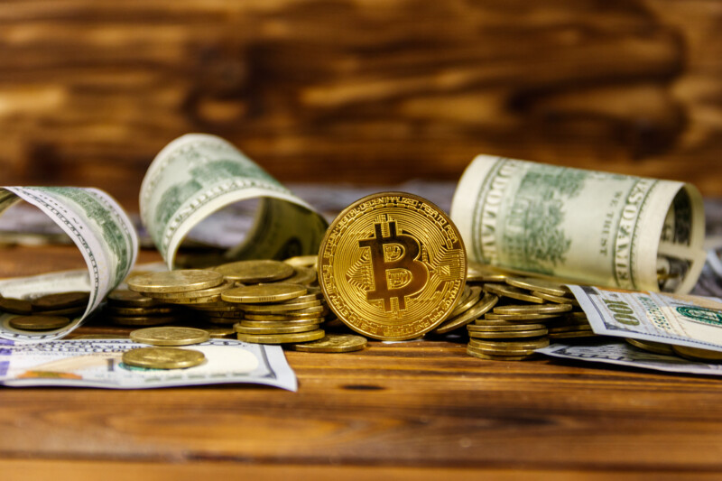 Bitcoin surrunded with dollars papaer bills