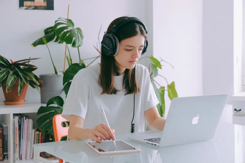 woman-in-white-shirt-using-silver-macbook