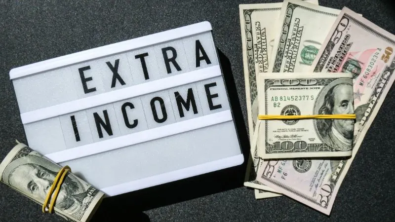 Cash and the Word Extra Income on a Board