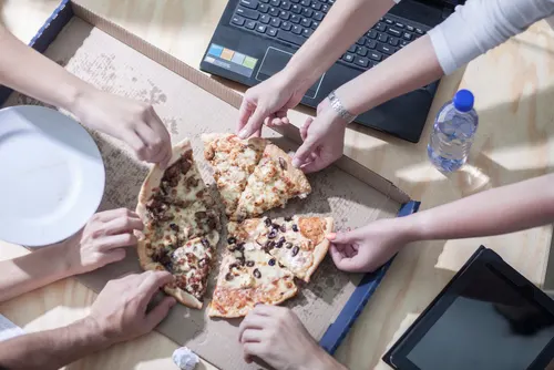 Hands on pizza on a box