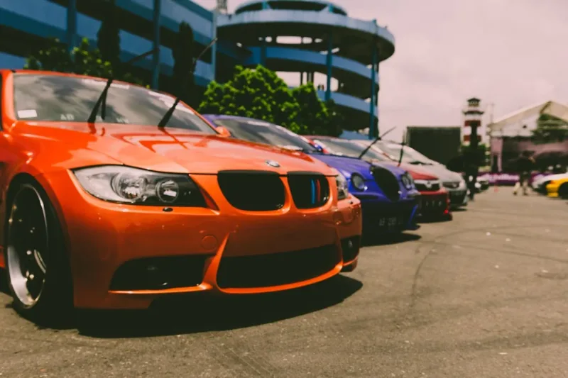 Cars Parked Outside on Concrete Road
